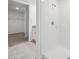 Bathroom with tiled floors, stand up shower, and a view into the closet at 3833 Giorgio Dr, Winter Haven, FL 33884