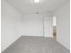 Neutral carpeted bedroom with light fixtures and a doorway to the bathroom at 3833 Giorgio Dr, Winter Haven, FL 33884