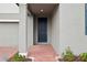 A welcoming front entrance features a dark-colored door and a brick path leading to it at 3833 Giorgio Dr, Winter Haven, FL 33884