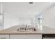 Kitchen island featuring a stainless steel double sink and sleek gray countertops at 3833 Giorgio Dr, Winter Haven, FL 33884