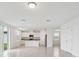 Open-concept living area connected to the kitchen, featuring an island and modern cabinetry at 3833 Giorgio Dr, Winter Haven, FL 33884