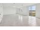 Bright living room with ceramic tile flooring, natural light, and sliding glass doors to the outside at 3833 Giorgio Dr, Winter Haven, FL 33884