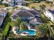 An aerial view of the home showcasing the pool, lush landscaping, and well-manicured backyard at 4089 Isabella Cir, Windermere, FL 34786