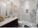 Modern bathroom featuring walk-in shower with white tiles and a dark wood vanity with white countertop at 4089 Isabella Cir, Windermere, FL 34786