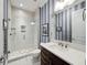 Modern bathroom featuring walk-in shower with white tiles and a dark wood vanity with white countertop at 4089 Isabella Cir, Windermere, FL 34786