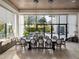 Bright dining room with large windows, a long wooden table, and elegant chandeliers at 4089 Isabella Cir, Windermere, FL 34786