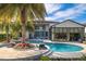 A luxurious pool and patio area with palm trees and lounge chairs, perfect for outdoor relaxation and entertainment at 4089 Isabella Cir, Windermere, FL 34786