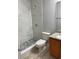 Modern bathroom featuring a tiled shower and vanity with granite countertop at 4220 Cleary Way, Orlando, FL 32828
