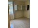 Small bedroom featuring tile floors, a built-in storage shelf, and large windows at 4220 Cleary Way, Orlando, FL 32828