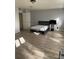 Spacious bedroom with wood-look flooring and a doorway to another room at 4220 Cleary Way, Orlando, FL 32828