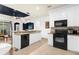 Modern kitchen with white cabinets and black appliances at 4220 Cleary Way, Orlando, FL 32828