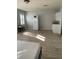 Open-plan living area boasts sleek flooring, a modern kitchenette, and abundant natural light at 4220 Cleary Way, Orlando, FL 32828