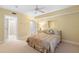 Bedroom with ceiling fan, ensuite bathroom access, and double closets at 432 Bouchelle Dr # 102, New Smyrna Beach, FL 32169