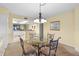 Dining area with glass-top table and view of kitchen at 432 Bouchelle Dr # 102, New Smyrna Beach, FL 32169