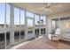 Relaxing sunroom featuring water views and ceiling fan at 432 Bouchelle Dr # 102, New Smyrna Beach, FL 32169