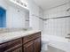 Bathroom with granite vanity and tiled shower/tub at 445 Fountainhead Cir # 164, Kissimmee, FL 34741