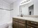 Bathroom with granite vanity and tiled shower/tub at 445 Fountainhead Cir # 164, Kissimmee, FL 34741