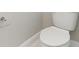 Modern bathroom with a white toilet, baseboards and convenient toilet paper holder at 5003 Railroad Vine Aly, Winter Garden, FL 34787