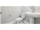 Powder room featuring a pedestal sink and a modern toilet offering a simple, functional design at 5003 Railroad Vine Aly, Winter Garden, FL 34787
