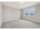 A bright, neutral bedroom with two windows offering plenty of natural light at 5003 Railroad Vine Aly, Winter Garden, FL 34787