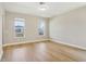 Bright and airy bedroom with wood-look flooring, featuring dual windows and neutral paint tones at 5003 Railroad Vine Aly, Winter Garden, FL 34787