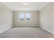 A neutral bedroom with two windows offering plenty of natural light at 5003 Railroad Vine Aly, Winter Garden, FL 34787