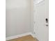 Clean entryway features a white door and trim, and light wood-look flooring, creating a welcoming entrance at 5003 Railroad Vine Aly, Winter Garden, FL 34787