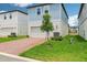 Charming two-story home featuring a blue and white exterior, brick driveway, and landscaped front yard at 5003 Railroad Vine Aly, Winter Garden, FL 34787