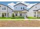 Attractive two-story home with a light blue exterior, a cozy front porch, and neat landscaping at 5003 Railroad Vine Aly, Winter Garden, FL 34787