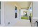 Inviting covered front porch with white columns, a black railing, and views of the streetscape at 5003 Railroad Vine Aly, Winter Garden, FL 34787