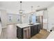 Gourmet kitchen includes a central island with bar seating, stainless steel appliances, and modern pendant lighting at 5003 Railroad Vine Aly, Winter Garden, FL 34787