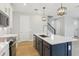 Modern kitchen with stainless appliances, a large island with seating, and sleek cabinetry create a stylish space at 5003 Railroad Vine Aly, Winter Garden, FL 34787