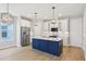 This kitchen features stainless appliances, stylish pendant lighting, and a large center island with barstool seating at 5003 Railroad Vine Aly, Winter Garden, FL 34787