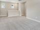 Loft area with plush carpeting, natural light, and neutral tones offers flexible living space upstairs at 5003 Railroad Vine Aly, Winter Garden, FL 34787