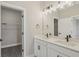 Modern bathroom with dual sinks, white countertops and cabinet, with a view of the walk-in closet at 5087 Railroad Vine Aly, Winter Garden, FL 34787