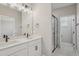 Stylish bathroom featuring dual sinks, white cabinets, and a modern glass shower at 5087 Railroad Vine Aly, Winter Garden, FL 34787