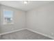 Neutral colored bedroom with plush grey carpet and a view from the bright window at 5087 Railroad Vine Aly, Winter Garden, FL 34787