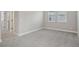 Spacious bedroom with plush carpet, neutral walls and large window for ample natural light at 5087 Railroad Vine Aly, Winter Garden, FL 34787
