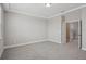 Large bedroom featuring grey carpet, crown molding and a view of an adjoining hallway at 5087 Railroad Vine Aly, Winter Garden, FL 34787