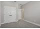 Light filled bedroom featuring grey carpet and white double doors at 5087 Railroad Vine Aly, Winter Garden, FL 34787