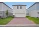 Two-story home featuring a brick driveway, garage and manicured lawn at 5087 Railroad Vine Aly, Winter Garden, FL 34787