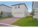 Two-story home with a brick driveway, garage, and well-maintained lawn at 5087 Railroad Vine Aly, Winter Garden, FL 34787