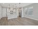 Modern kitchen with white cabinets, stylish lighting, a central island, and stainless steel appliances at 5087 Railroad Vine Aly, Winter Garden, FL 34787