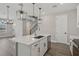 Open kitchen with stone countertops, stainless steel appliances and island open to the living room at 5087 Railroad Vine Aly, Winter Garden, FL 34787