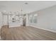 Open-concept living space with wood floors, dining area, a central island, and stainless steel appliances at 5087 Railroad Vine Aly, Winter Garden, FL 34787