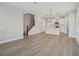 Spacious open-concept living area, featuring wood-look floors and connecting stairs at 5087 Railroad Vine Aly, Winter Garden, FL 34787