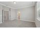 Spacious bedroom with grey carpet, crown molding and a view of an adjoining bathroom at 5087 Railroad Vine Aly, Winter Garden, FL 34787
