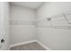 Walk-in closet with white metal shelving and plush carpet at 5087 Railroad Vine Aly, Winter Garden, FL 34787