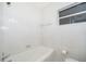 Simple bathroom with shower/tub combo and white tile at 5416 Parkway Dr, Belle Isle, FL 32809