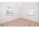 Bright bedroom with tile flooring and two windows at 5416 Parkway Dr, Belle Isle, FL 32809